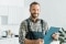 Friendly man in overalls with a notepad
